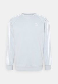 Světle šedá mikina se bílým třípruhovým designem na ramenou. Má klasický kulatý výstřih a žebrované manžety. Na hrudi je umístěno logo.