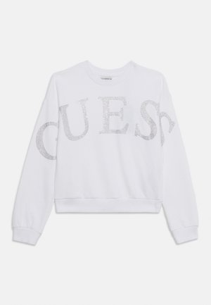 White long-sleeve sweatshirt with large sparkling rhinestone letters spelling "GUESS" across the chest and sleeves.