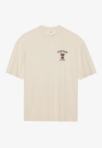 Beige bomulds t-shirt med korte ærmer, der har et brunt grafik af en kaffekop og teksten "COFFEE LOVERS" på venstre brystområde.