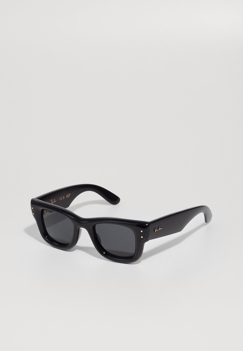 Black sunglasses with a glossy finish, rectangular frame, dark lenses, and gold logo accents on the temples. Two gold dots on each front corner.