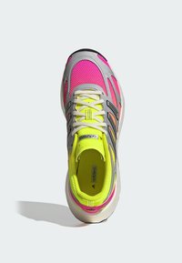Neon yellow and pink athletic shoe with a breathable mesh upper, silver accents, black stripes, and a cushioned sole.