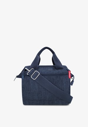 Compact navy blue fabric shoulder bag with dual handles, adjustable strap, front zipper pocket, and red brand tag on the side.