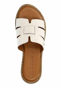 White slide sandal with memory foam insole, wide dual strap design, tan footbed, and decorative studs along the sole's edge.
