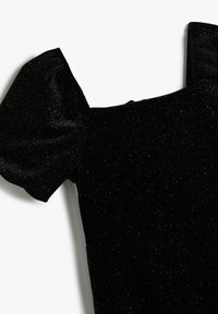 Svart sammetklänning med korta puffärmar, en figursydd livdel och en subtil glans genom hela tyget. Slät textur utan mönster.