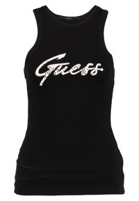 Débardeur noir sans manches en matière lisse, avec un logo "Guess" en sequins argentés sur la poitrine. Coupe ajustée avec un col rond.