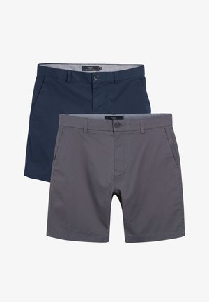 Dwie pary szortów: jedne w kolorze granatowym, drugie szare. Obie mają prosty krój, zapięcia na guziki, kieszenie z przodu oraz gładką teksturę materiału.
