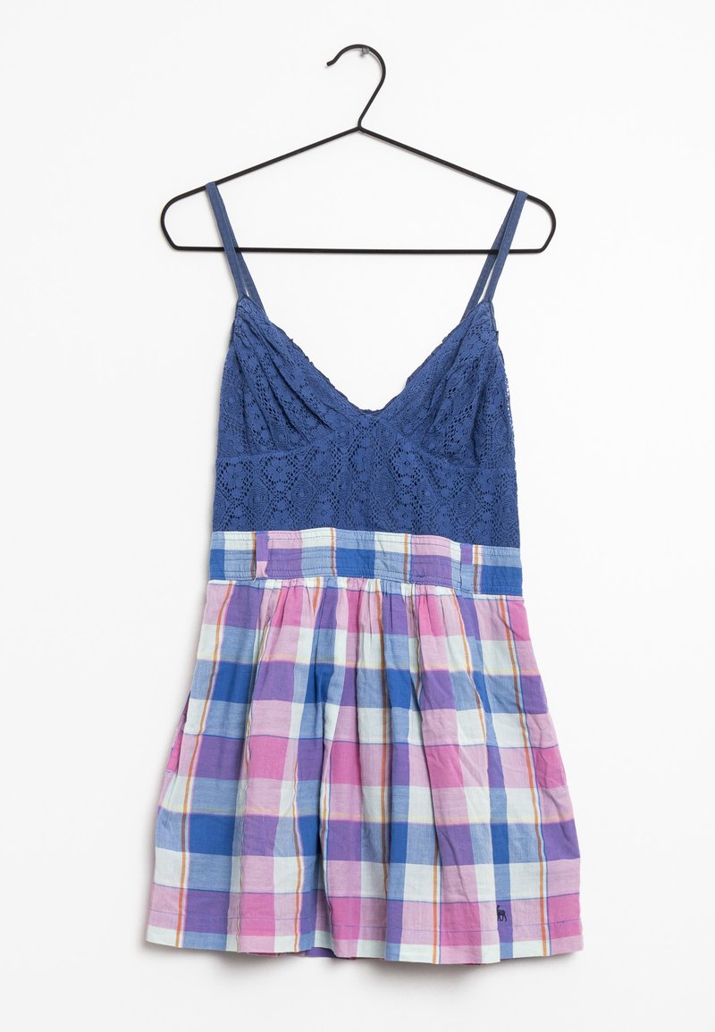 Top de encaje azul con escote en V y tirantes ajustables; en la parte inferior lleva un patrón de cuadros multicolores en rosa, azul y blanco. Diseño de falda acampanada.