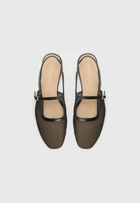 Black mesh slingback shoes with a square toe, a thin, glossy strap across the foot, and a gold buckle accent. Minimalist design with textured fabric.