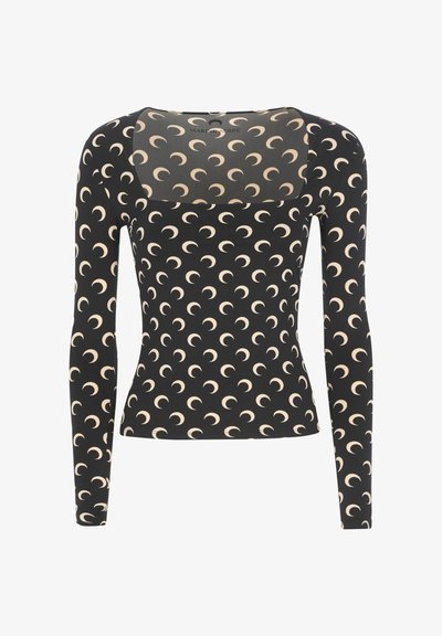 Top nero a maniche lunghe con scollo rotondo, caratterizzato da un motivo a mezzaluna color crema su tutta la superficie e un pannello posteriore trasparente.