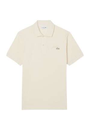 Kremowa koszulka polo wykonana z bawełny, z kołnierzykiem, krótkimi rękawami i zielonym haftowanym logo krokodyla na lewej piersi.