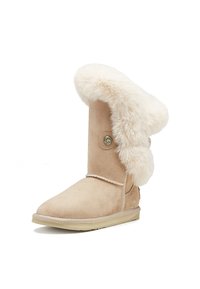 Beige suede boot with a fluffy cream faux-fur collar, rounded toe, decorative button, and a flat rubber sole. Textured surface throughout.