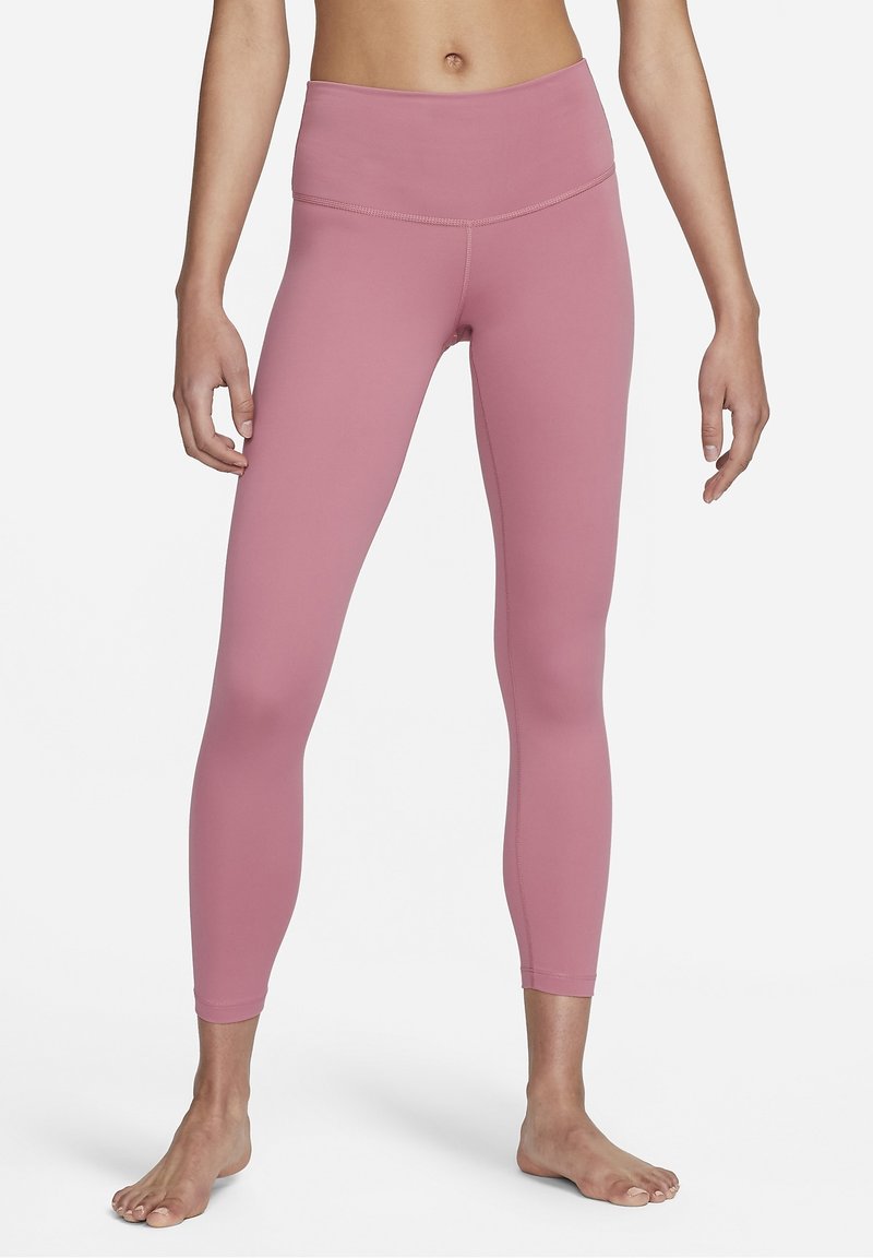Rosa atletiska leggings med hög midja, slät textur, åtsittande design och subtil sömdetalj längs sömmarna.