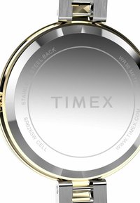 Silver and gold-tone stainless steel watch back with a polished finish, featuring engraved text, water resistance, and battery information.