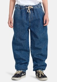 Zachte denim broek in donkerblauw, met een elastische tailleband met trekkoord, zijzakken, contrasterende stiksels en taps toelopende boorden.