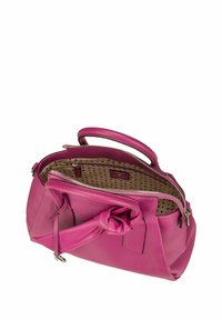 Pink leather handbag with a zip closure, smooth texture, and knotted accent detail on the handle. Interior features a polka dot pattern.