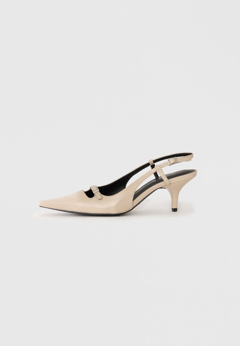 Beige leather slingback shoe with a pointed toe, small heel, and cut-out design, featuring a buckle accent on the strap.