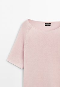 Light pink short-sleeve knitted sweater with a round neckline and visible knit texture, displayed on a plain white background.