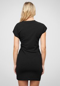 Must have mustrdise plaster of soft fabric, featuring short sleeves, a round neckline, and a fitted design that stops above mid-thigh.