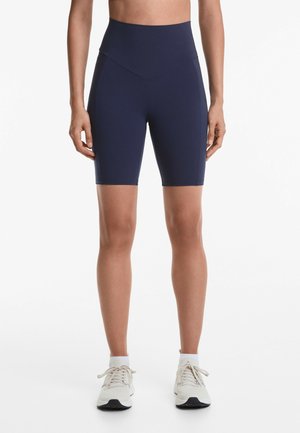 Hochtaillierte Fahrradhose in Marineblau mit glatter Textur und figurbetontem Design, ausgestattet mit seitlichen Paneelakzenten.