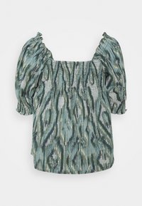 Haut à manches bouffantes avec motif ikat bleu et vert. Corsage smocké avec encolure carrée. Tissu doux et texturé avec détails froncés.