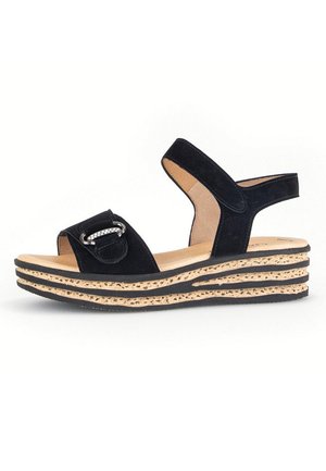 Black suede wedge sandals featuring two wide straps, a metallic buckle accent, and a layered cork platform sole.