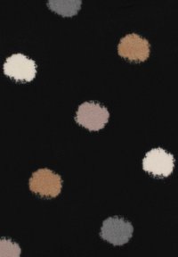 Black fabric features scattered, soft-edged dots in beige, white, gray, and light pink tones. The texture appears smooth and lightweight.