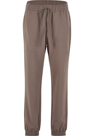 Pantalons de survêtement marron en matériau doux, dotés d'une taille élastique, d'un cordon de serrage ajustable et de poignets élastiques aux chevilles.