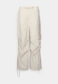 Lys beige cargo bukser med løs pasform, der har to sidelommer, strammesnor i taljen og samlede kanter ved anklerne.