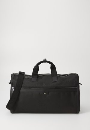 Sac de sport noir en nylon texturé, doté de poignées doubles, d'une bandoulière amovible et d'une poche zippée à l'avant avec logo.