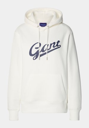 Hvit hettegenser laget av myk stoff med en frontlomme og en stor marineblå "Gant" logo over brystet. Snøring i hetten inkludert.