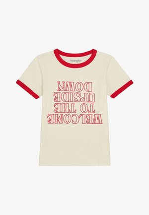 Cream-colored t-shirt with red ringer collar and sleeves. Features upside-down text: "WELCOME TO THE UPSIDE DOWN" in bold red font.