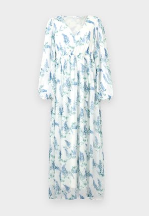 Dlhé, voľné šaty vyrobené z priesvitnej látky. Majú bielu základňu s modrými kvetinovými vzormi, výstrih do V a dlhé, nafúknuté rukávy.