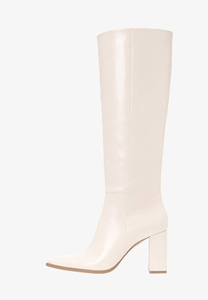 Bottes en cuir blanc hauteur genou avec un talon carré, bout carré, texture lisse et détails de couture minimaux.
