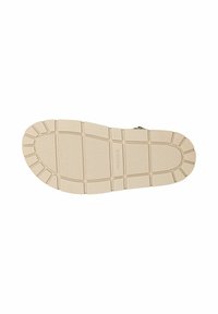 Suola di una scarpa, in gomma beige con una finitura testurizzata. Presenta un battistrada a motivo per una migliore aderenza e un'area centrale liscia. Logo del marchio visibile.