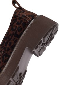 Stivale alla caviglia in suede marrone con motivo a stampa leopardata, dotato di una suola in gomma robusta e testurizzata e di un'etichetta per una facile calzata.