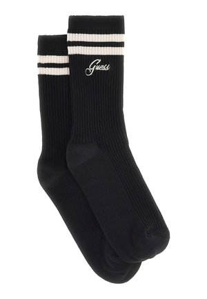 Calzini neri a coste con strisce bianche sulla parte superiore. Presentano il logo "Guess" ricamato in bianco. Realizzati in un tessuto morbido, ideali per un abbigliamento casual.