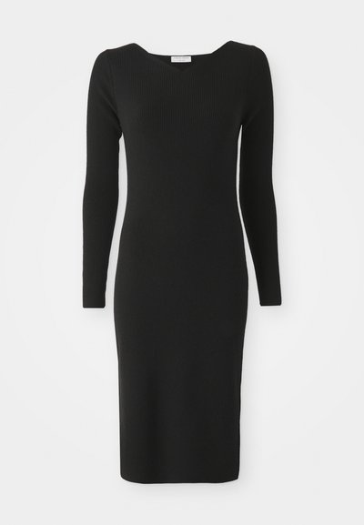 Black ribbed knit dress with a fitted silhouette, long sleeves, and a V-neck design, smooth texture, knee-length, minimalist style.