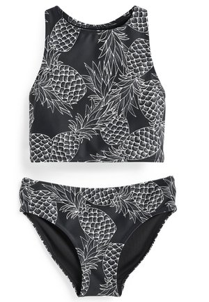 Svart baddräkt i två delar som består av en ärmlös croptop och underdel, prydd med vita ananasteckningar och en slät, elastisk textur.