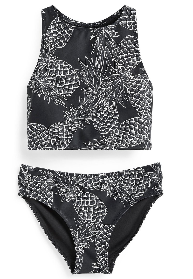Svart baddräkt i två delar som består av en ärmlös croptop och underdel, prydd med vita ananasteckningar och en slät, elastisk textur.