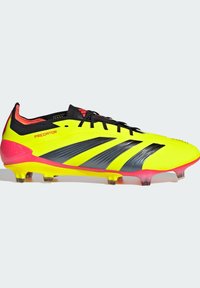 Scarpino da calcio giallo brillante con accentuazioni nere e rosa, caratterizzato da un design aerodinamico, superiore testurizzato e tacchetti stampati per una maggiore aderenza.