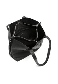 Sac en cuir noir avec un intérieur spacieux, présentant des zips et des clous argentés sur un côté. Texture lisse et longues poignées.