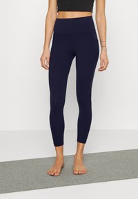 Marine høy midje tights laget av stretchy stoff med en glatt tekstur, som har en konturdesign i sømmene og ankel-lengde snitt.
