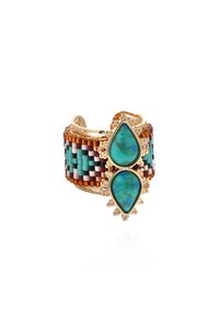 Beaded cuff bracelet featuring a multicolored woven design, two teardrop turquoise stones set in gold-tone accents.