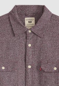 Red and white checkered short-sleeve shirt with a collar, two front pockets, and off-white buttons. Features a woven label inside the collar.