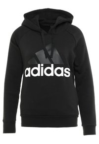 Schwarzer Kapuzenpullover aus weichem Material. Besitzt ein großes weißes "adidas"-Logo und ein dreieckiges schwarzes Akzentdesign auf der Vorderseite.