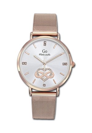 Montre-bracelet à bracelet en maille or rose avec cadran blanc, index en cristal, motif décoratif en forme de cœur et marque "Go Mademoiselle" sur le cadran.