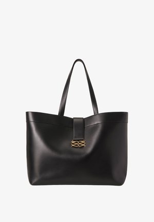 Sac fourre-tout en cuir noir avec des poignées plates, présentant un détail en métal doré sur une sangle centrale et une texture lisse et brillante.