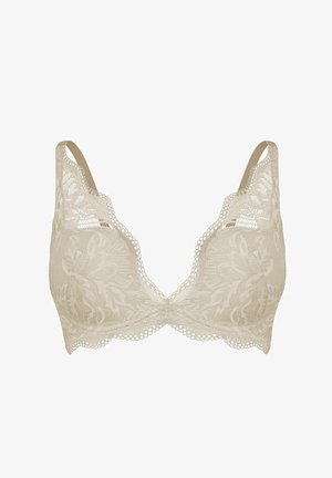 Beżowy koronkowy biustonosz z kwiatowym wzorem, falistymi krawędziami i regulowanymi ramiączkami, zaprojektowany dla lekkiego podparcia i dekoracyjnego noszenia.