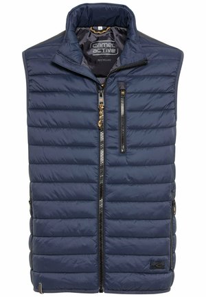 Navy blue insulated vest with diagonal quilted pattern, high collar, front zipper, two zippered side pockets, and branding label.