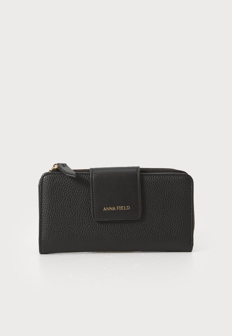 Black leather wallet with a textured finish, featuring a magnetic flap closure and gold lettering "ANNA FIELD" on the front.
